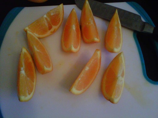 Cut the citrus fruit in half again, and one more time into small sections.