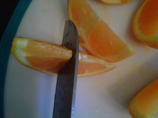 Cut one sliver of fruit 3/4 of the way through to make a garnish for your glass. 