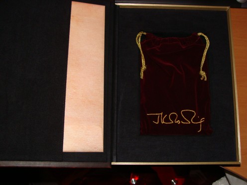 Inside the outer casing. The envelope containing J.K. Rowling's illustrations and the book inside the velvet pouch with J.K's signature embroidered.
