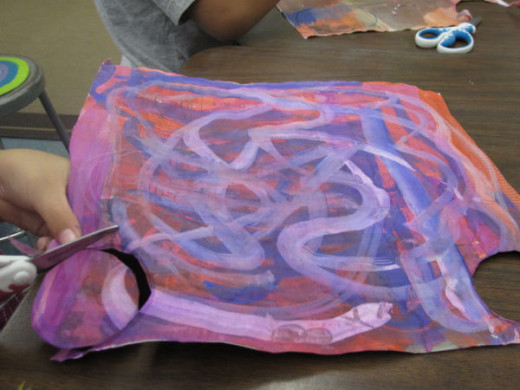 Painted paper is cut for assembly.
