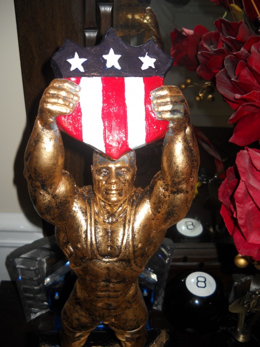 Athletic Statue holding an award that represents the flag.