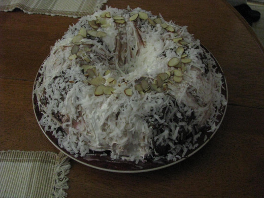 9.  This was supreme.... Alternated Whipped Vanilla with milk chocolate sprinkled with sweetened Coconut and top middle dotted with sliced almond- Center Black cherry icing and whipped cream mixed together.