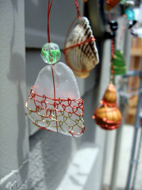 Wire wrapped tumbled glass.