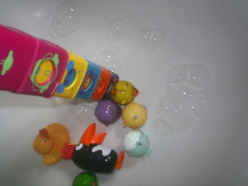 Add toys and bubbles to water