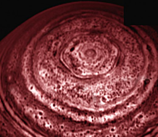 Using infrared, the Cassini spacecraft prizes out bizarre cloud formations at the planet's north pole.