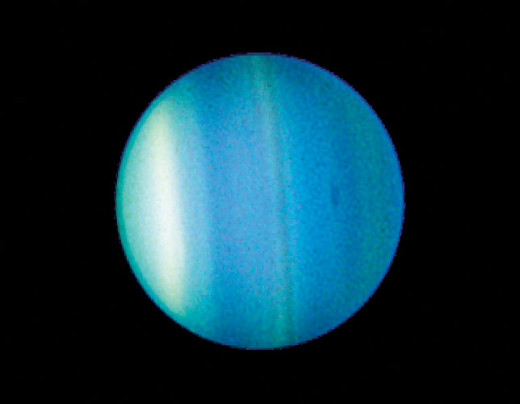 Color-enhanced view of the planet Uranus as seen by the Hubble Space Telescope. (Without upping the color contrast, it's a fuzzy blue ball the color of a robin's egg.) 