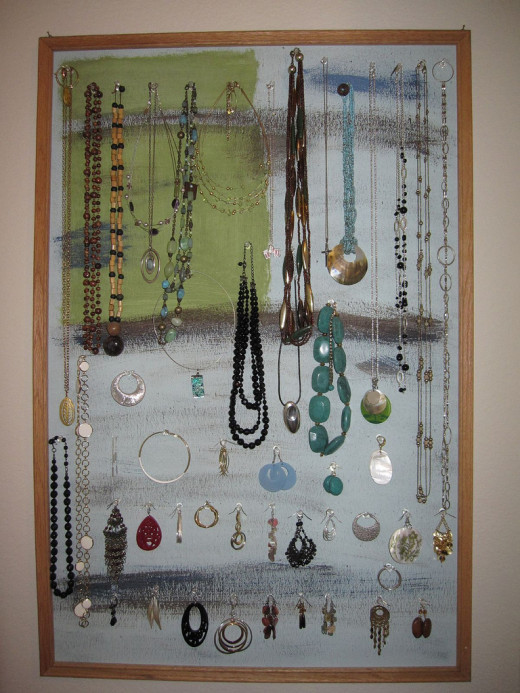 A painted corkboard turned into a jewelry organizer