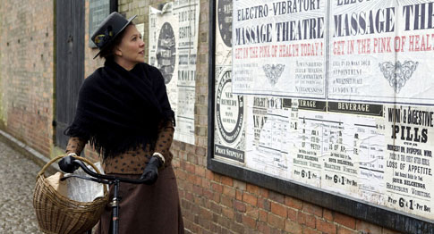 Spitfire Charlotte looking at posters advertising her father's miracle cure for female hysteria. Spitfire Charlotte looking at posters advertising her father's miracle cure for female hysteria.