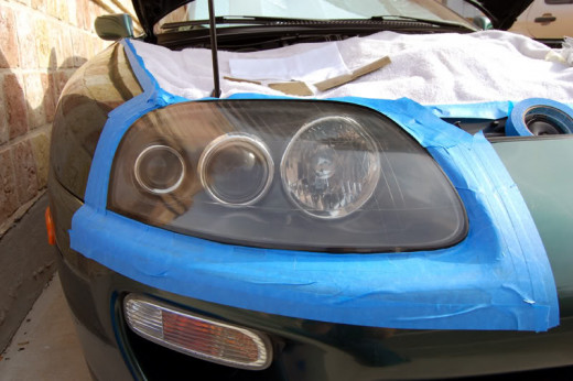A masked off headlight, ready for polishing