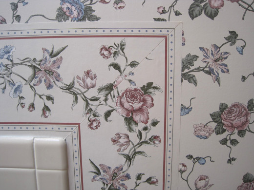 Nice white tile next to old wallpaper.