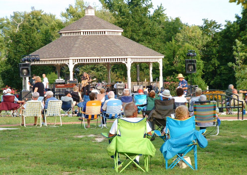 Residents and visitors enjoying a free summer concert at the park. 
