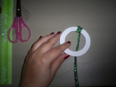 Wrap the green sparkly pipe cleaner around the cardstock.