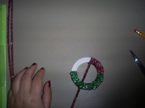 Keep wrapping pipe cleaners around the Christmas reath carstock template.