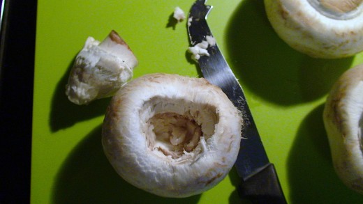 Remove the stems carefully from the mushroom leaving a cavity.