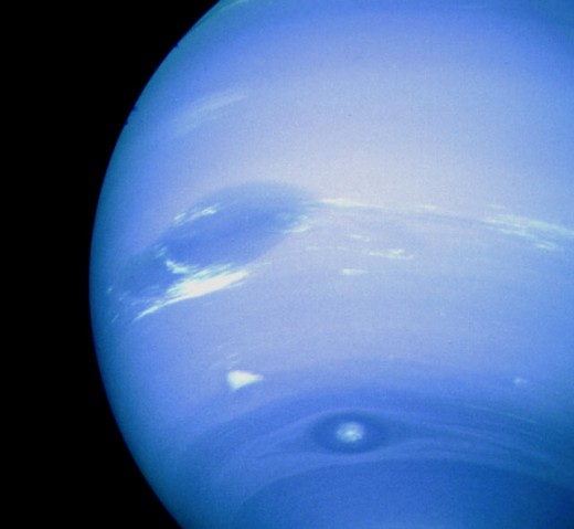 Neptune's Great Dark Spot - a massive storm that spins anti-clockwise. You can see other features in the clouds of Neptune, suggesting some interesting weather on the planet