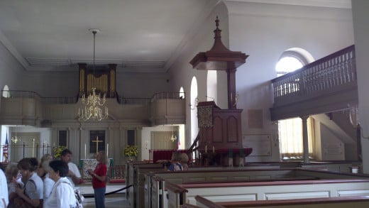 A picture inside Bruton Parish of the pulpit.  Notice the "sounding board" on top to project volume and the elevated position of the pulpit also.