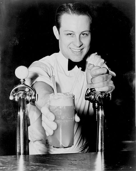 Soda Jerk passing ice cream and soda between two fountains 1936.