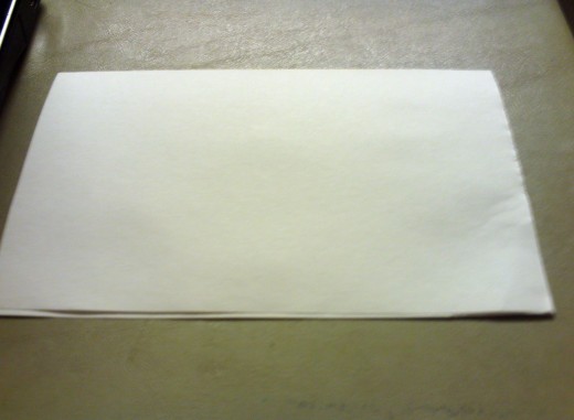 Fold the sheet of paper into a half-fold card.