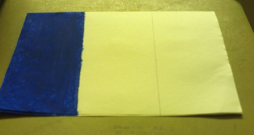Here I have colored in the blue portion of French flag with the oil pastel of that color.