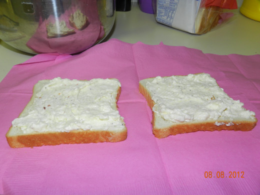 Spread the cream cheese mixture on the bread slices.