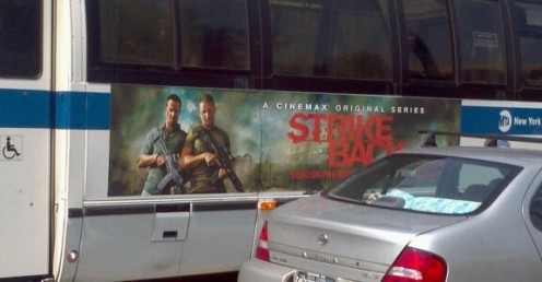 On the side of a bus near the Citi building.