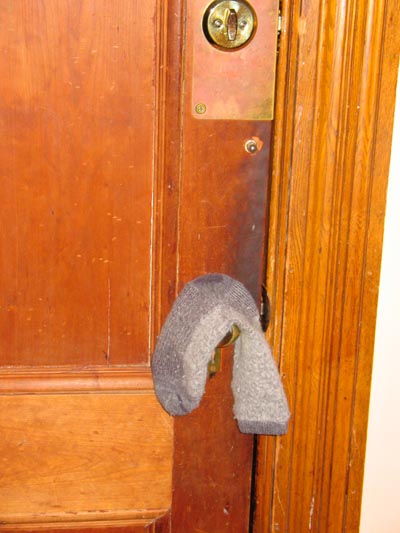 Sock hanging on the doorknob.  Obviously it had been trying to open the door and escape. 