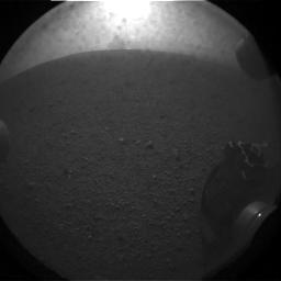 The "pyramid" shape seen in the first hazcam shots behind Curiosity is the last of the dust cloud kicked up by the sky crane's crash. (It hit 20 seconds before this photo, taken 40 seconds after touchdown.) JPL planned this photo hoping to spot it.