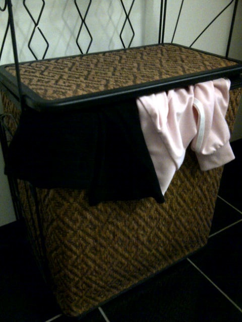 The overflowing laundry bin~