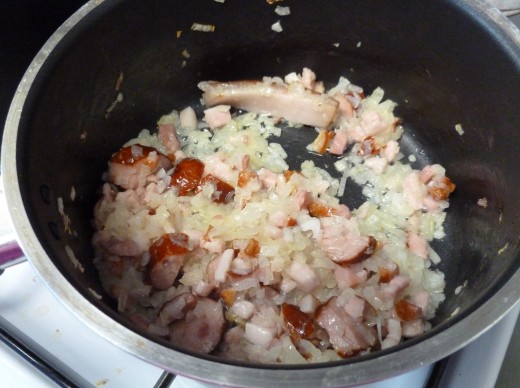 start by frying the onion, bacon and sausage