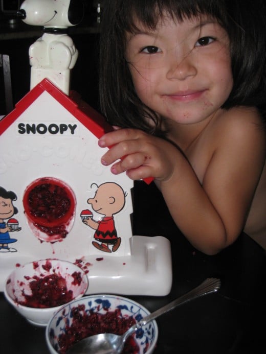 Here's my daughter shaving frozen berries with her Snoopy Sno-Cone Machine. Berries are a little softer than ice cubes, so easier for kids to grind.