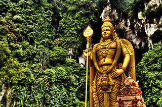 The 43m golden statue of a Hindu God is an attraction for those who cannot climb the mountainous cave temple.