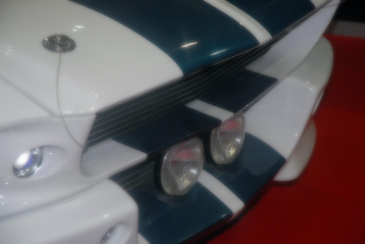 This Photograph of a bonnet of a car is not fully sharp. The hint of blurriness gives the perception of speed even though the car is stationary.