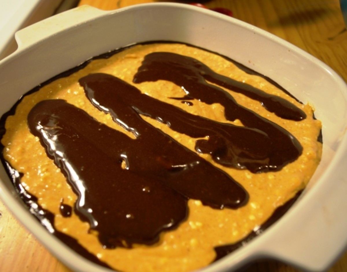 Pour the pumpkin batter on top of the brownie batter and then use the brownie batter you set aside and drizzle over the pumpkin batter in a zig-zag pattern.
