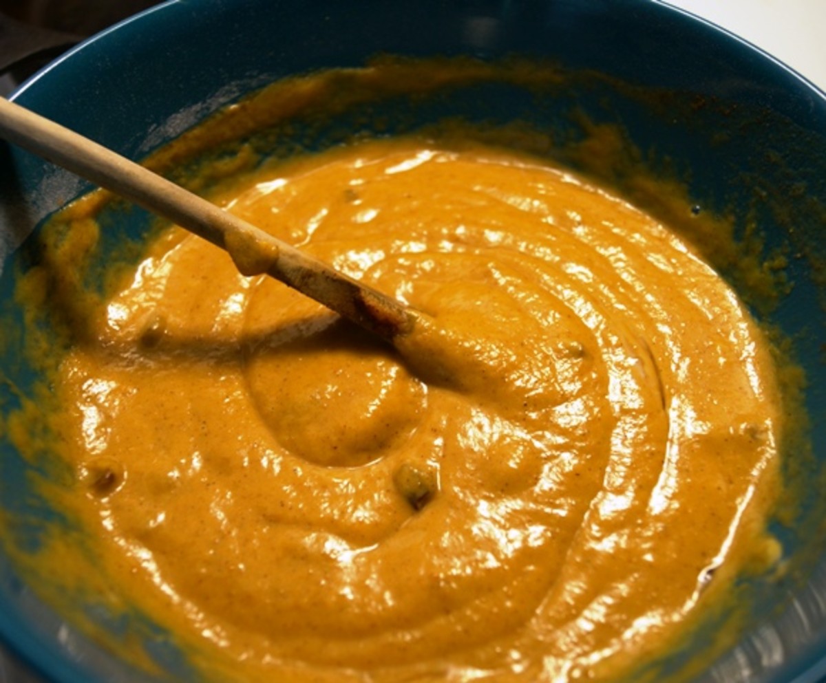 Then add in everything else, including the pumpkin puree, eggs, oil, sugar, spices and nuts.