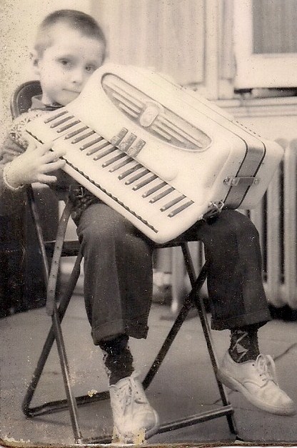 Learning to play the accordion at 6 years old.