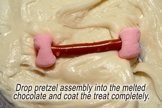 Coat pretzel assembly completely with the melted chocolate.
