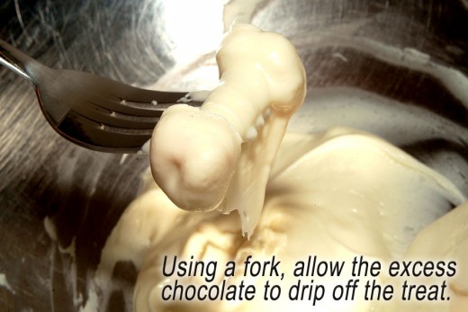 A fork works great for lifting out, and dripping off the extra chocolate from the treat.