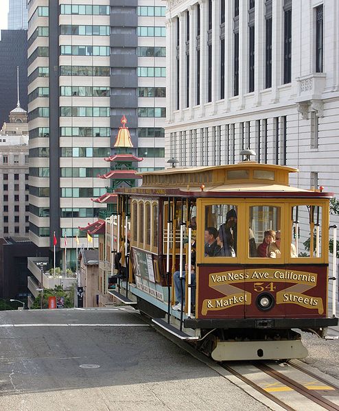 This cable car coming uphill in Chinatown in San Francisco was photographed by Fred Hsu on December 25, 2006. The cable car has just crested the hill. Look how steep the street is!