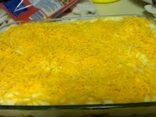 Cover the mashed potatoes with a second cheese layer.  Shepherd's Pie ready to bake.