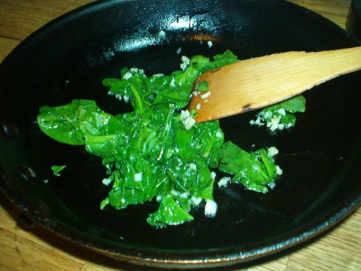 Sauteed spinach and garlic make the bottom layer of the quiche.