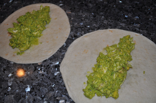Lay out your tortillas and divide the mixture between the two.