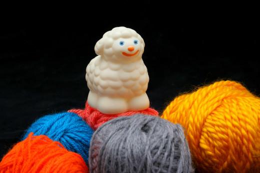 SHEEP OVER BALLS OF YARN by Erdosain  DESCRIPTIONWhite sheep over balls of yarn. Concep: before and after
