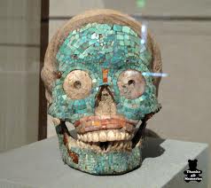 Turquoise encrusted skull image of the diety.
