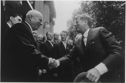 President Kennedy and Khrushshev shake hands.