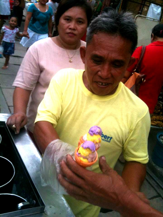 Noy Sito, the ice cream man is a neighbour back home. He goes to his usual spot in the afternoon selling ice cream and that is why it is easy to spot him.