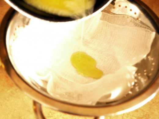 Pour melted butter through a strainer with cheesecloth.