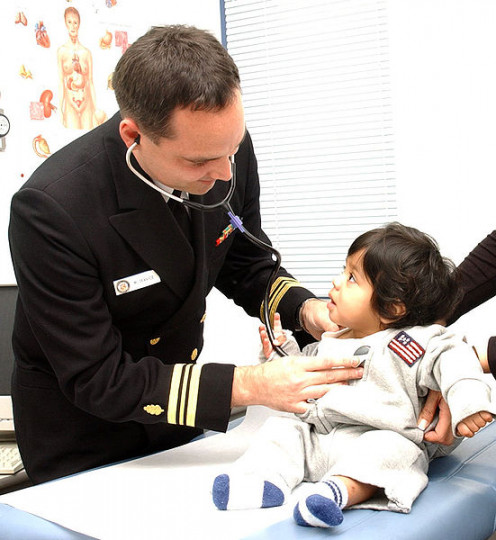 U.S. Naval Hospital Yokouska, Japan (October 27, 2003) -- Family Nurse Practitioner Lieutenant Commander Michael Service cares for a young girl at the hospital.