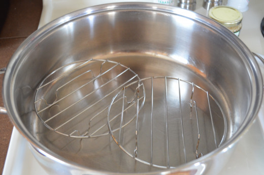 Use a pan that's large enough to fit some kind of rack in to keep the fish up out of the poaching or steaming liquid.