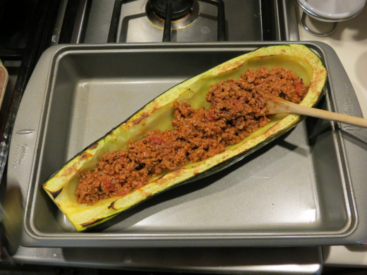 Fill zucchini half with ground beef and tomato sauce mixture and top with mozzerella cheese.  Bake at 375 degrees for 15 minutes or until the cheese is slightly browned.