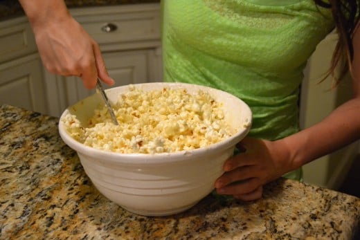 It might seem difficult to get all the popcorn coated with marshmallow mixture, but it's really pretty easy. Just keep stirring and turning up from the bottom of the bowl.